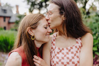 Woman kissing woman on the head tenderly