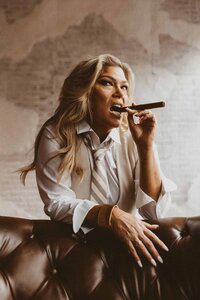 woman holding a cigar