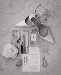 wedding invitation suite with other details like heels, perfume, and jewelry