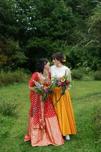 Two bride pose for photo at Sadie Belle Farm wedding