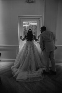 phoenix bride and groom look out window