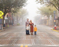 Family standing in the middle of a street