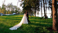 bride and groom kiss near lake in Round Lake MN