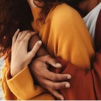 Close-up of a couple embracing with warmth and tenderness, symbolizing trust and emotional healing through the Infidelity Recovery Program by Relationship Experts and Idit Sharoni, LMFT.