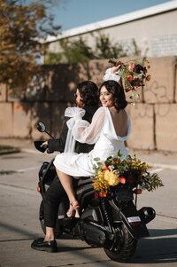 Bride and groom on a vespa bike