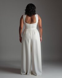 Back view of a midi wedding dress with peplum