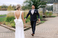 Groom sees his Minnesota bride for the first time, arms open in awe and excitement during their emotional first look at a Minnesota wedding, captured by Toly Dzyuba Photography.