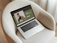 A laptop sitting on a chair with Kayla Cindy Photo's website pulled up.