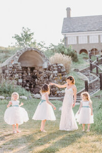 Bride twirling with three flower girls