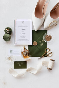 Flat lay photo of the wedding invitations, shows, jewelry, etc.