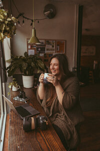 Traveling Family Photography, woman enjoying a warm drink while sitting at a table
