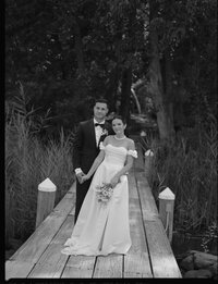 Alexandra Eveland leanding on her boyfriend's shoulder while they look towards the camera