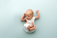 Newborn boy in blue in studio newborn session 
