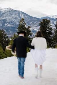 Bride and groom walk to Sapphire Point Overlook during winter elopement.
