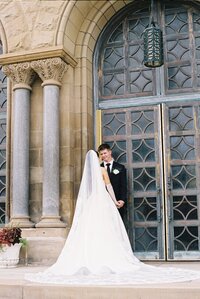 bride and groom sharing a happy moment, dance at destination wedding, white wedding dress with long train, outdoor wedding photography