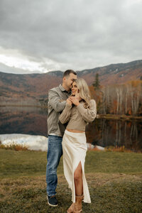 Authentic engagement photography of a couple walking through fields.