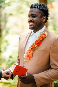 Floral lapel on groom by wedding planner near me