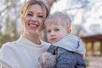 Mother holding young son in arms