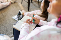 notebook of notes in lap