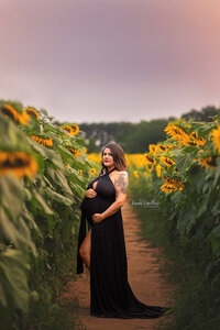 Pregnant woman in a sunflower field by Susan VanNess photography, a Raleigh maternity photographer