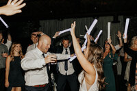 Bride and groom dance at reception with friends
