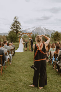 bride and groom sit in front of window