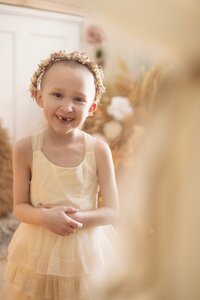 Little girl wearing a flower crown smiling