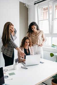 Three women looking at a laptop