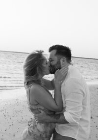Couple kissing passionately on the beach by Shelby Ann Photos, specializing in engagement photography florida