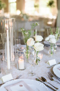 A detail photo of floral arrangements at the head table during a wedding at Pinnacle Golf Club