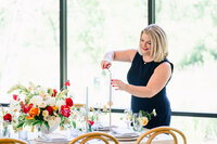 Austin wedding planner lighting taper candles during reception setup, focusing on intentional, beautiful wedding day details.