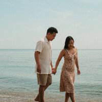 A photo of Cindy and her husband on the beach side.