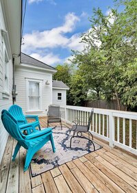 Wooden porch overlooking back yard of this 3-bedroom, 2-bathroom vacation rental home near the Silos and Baylor in Waco, TX