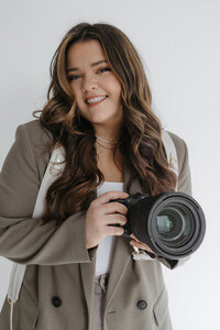 Photographer smiling, reviewing branding and website design for creatives, by Palme Design Co