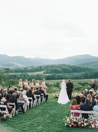 Romantic vineyard wedding ceremony surrounded by rolling hills at Pippin Hill, photographed by a fine art destination wedding photographer in Charlottesville