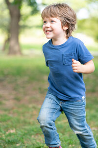 boy smiling and running