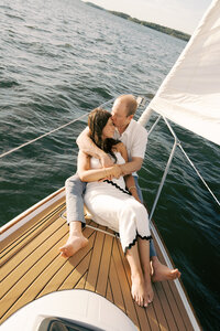couple snuggling on a sailboat on a lake in Nashville 