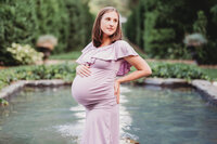 Pregnant woman wading in shallow pool