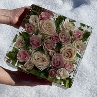 brides light pink wedding flowers preserved in a square resin block
