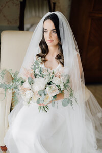 bride-sitting-in-chair-in-bridal-suite