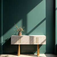 Modern console table with gold legs and a small vase, set against a green wall with dramatic sunlight and shadow patterns.