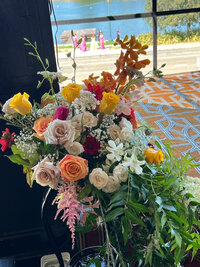 Vibrant floral arrangement with a lake view in the background