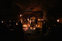 Bride & groom saying vows by candlelight in the Caves of Hella in Iceland!