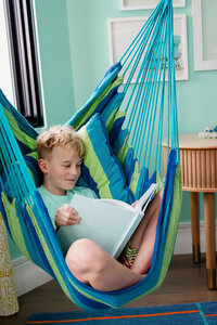 Bunk beds with blue blankets against light blue wall