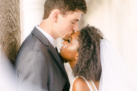 Handsome groom kissing black bride  for their  multicultural  wedding in Phoenix Arizona
