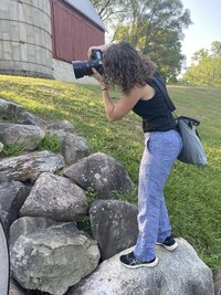 Behind-the-scenes moment of a high school senior getting final touches before a portrait session with an Ann Arbor photographer.