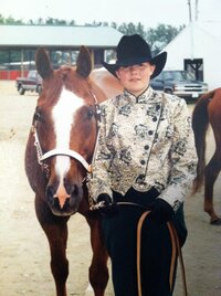 Hiliary in western show gear with her First AQHA gelding Suggestive Circle, Also known as Charlie.