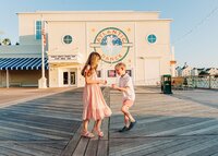 Kids dancing on the boardwalk outside of the Atlantic Dance Hall near Disney's Boardwalk Hotel