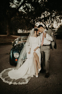 Luxury florida wedding photographer, luxury jacksonville florida wedding photographer, bride and groom portraits at wedding, bride and groom in antique getaway car at wedding,