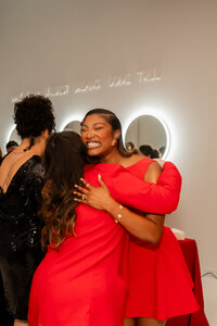 Women hugging at Christmas Party for JAcksonville Vendors